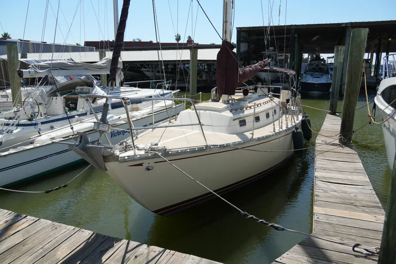 Slide: The Image of 1970 Cheoy Lee 38A sailboat docked at a marina. - 10
