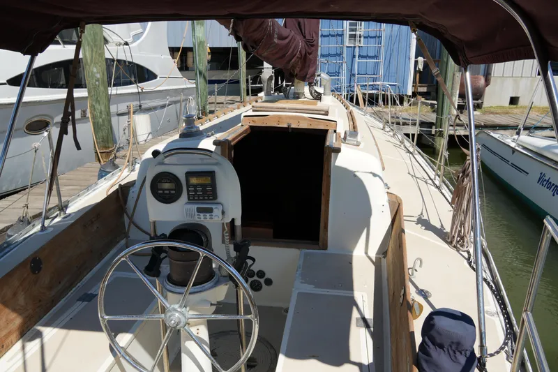 Slide: The Image of 1970 Cheoy Lee 38A sailboat cockpit with steering wheel and navigation instruments. - 12