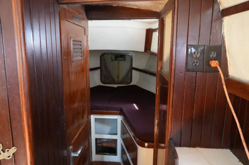 Slide: The Image of Interior of 1970 Cheoy Lee 38A sailboat with wooden paneling and cozy cabin space. - 20