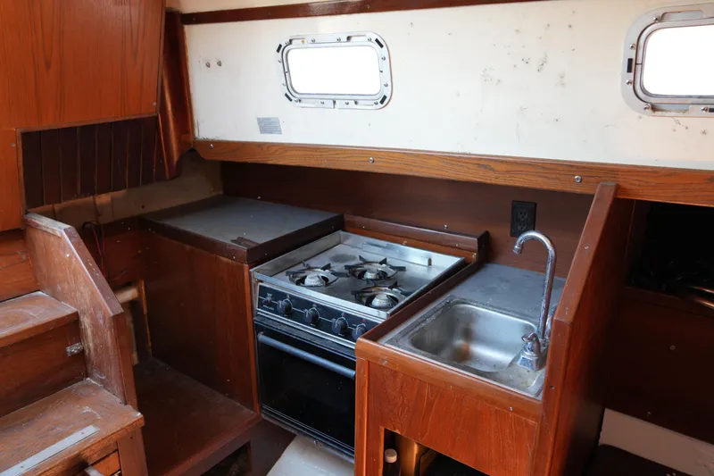 Slide: The Image of 1970 Cheoy Lee 38A yacht interior with stove and sink in wooden galley. - 24