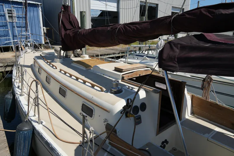 Slide: The Image of 1970 Cheoy Lee 38A sailboat docked, featuring classic design and wooden accents. - 3