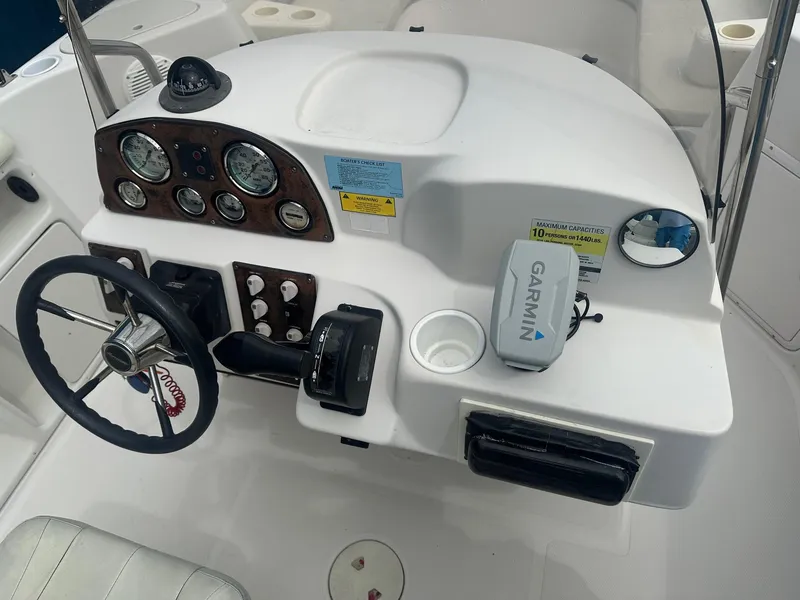 Slide: The Image of 2003 Godfrey Hurricane FD211 boat dashboard with Garmin GPS and control panel. - 4