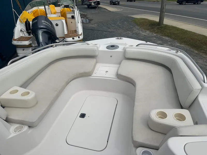 Slide: The Image of 2003 Godfrey Hurricane FD211 boat interior with cushioned seating and cup holders. - 6