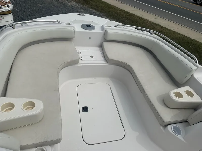 Slide: The Image of 2003 Godfrey Hurricane FD211 boat interior with cushioned seating and cup holders. - 7