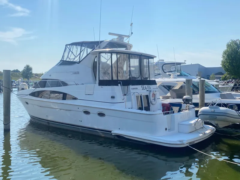 The Image of 2002 Carver 444 Cockpit Motor Yacht docked in marina. - 0
