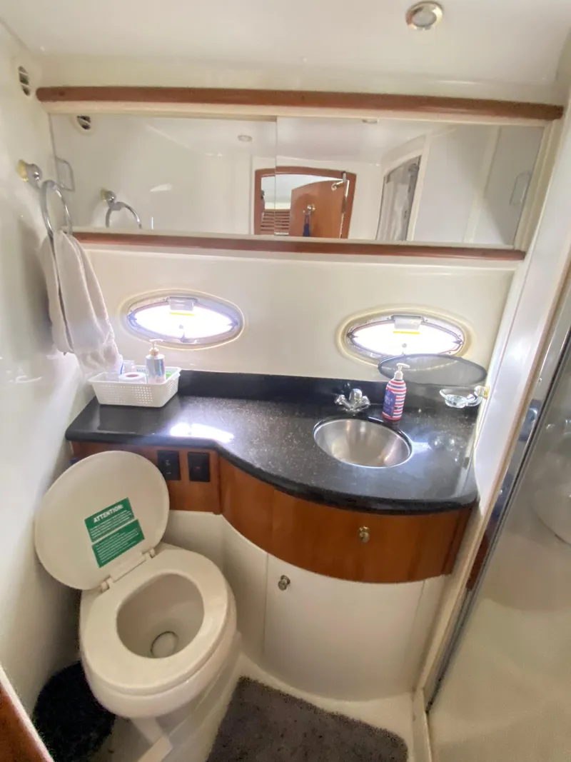 Slide: The Image of 2002 Carver 444 Cockpit Motor Yacht bathroom with sink, toilet, and mirror. - 20