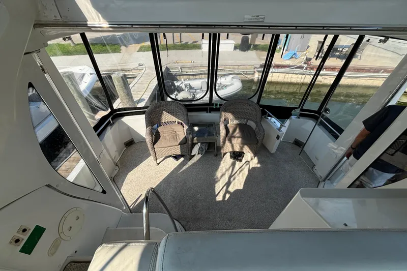 Slide: The Image of 2002 Carver 444 Cockpit Motor Yacht interior with seating and waterfront view. - 3