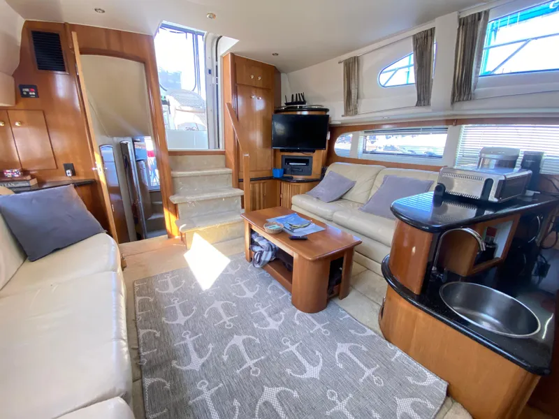 Slide: The Image of Interior of 2002 Carver 444 Cockpit Motor Yacht with cozy seating and nautical decor. - 5