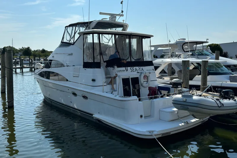 Slide: The Image of 2002 Carver 444 Cockpit Motor Yacht docked at marina, rear view. - 8