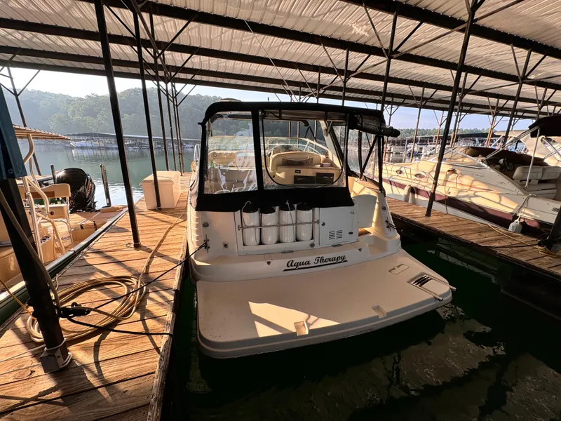 Slide: The Image of 2002 Rinker Fiesta Vee 342 docked in a covered marina. - 11