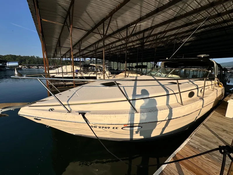 Slide: The Image of 2002 Rinker Fiesta Vee 342 docked under a covered marina. - 14