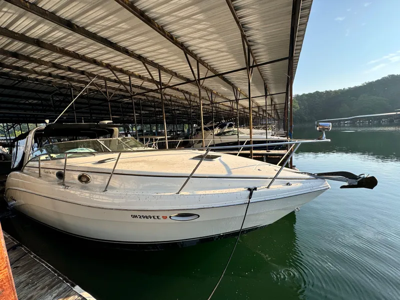 Slide: The Image of 2002 Rinker Fiesta Vee 342 boat docked under a covered marina. - 2