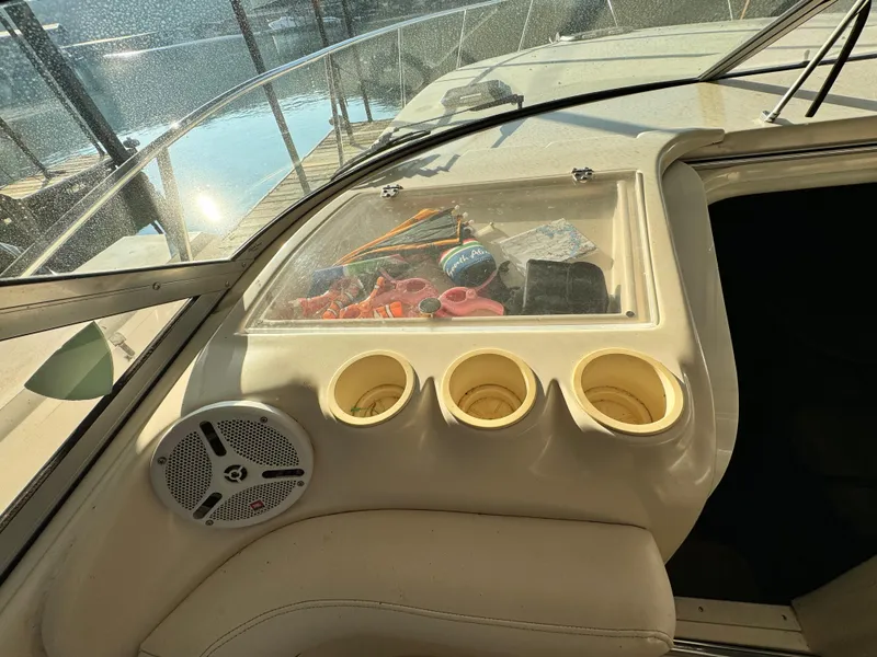 Slide: The Image of 2002 Rinker Fiesta Vee 342 boat dashboard with cup holders and storage compartment. - 31