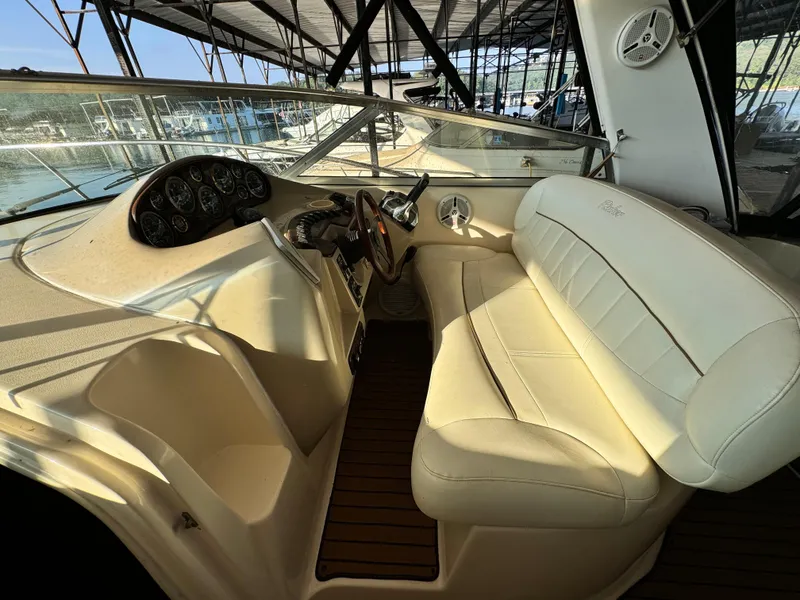 Slide: The Image of 2002 Rinker Fiesta Vee 342 boat interior with beige seating and dashboard. - 32