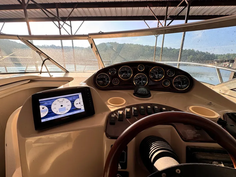 Slide: The Image of 2002 Rinker Fiesta Vee 342 boat dashboard with gauges and navigation screen. - 34