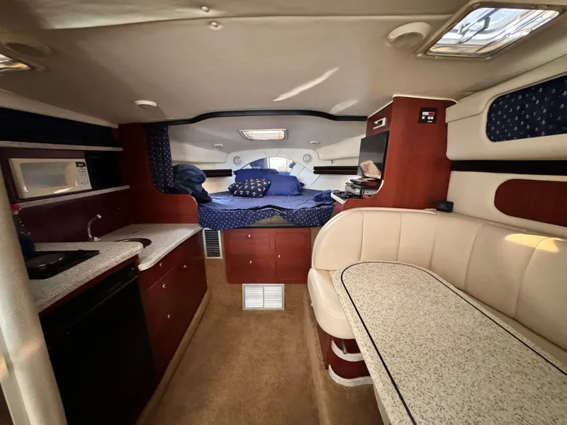 Slide: The Image of Interior of 2002 Rinker Fiesta Vee 342 boat with cozy seating and kitchenette. - 42