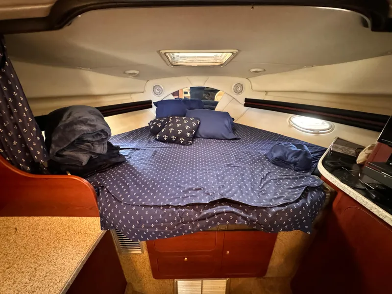 Slide: The Image of Cozy cabin interior of 2002 Rinker Fiesta Vee 342 with blue bedding. - 47