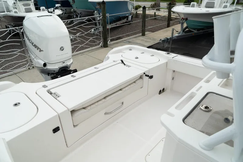 Slide: The Image of 2023 Blue Wave 2600 Makaira boat interior with storage and motor. - 14
