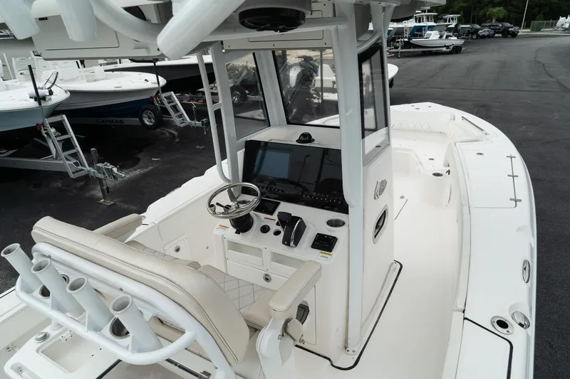 Slide: The Image of 2023 Blue Wave 2600 Makaira boat interior with steering console and seating. - 17
