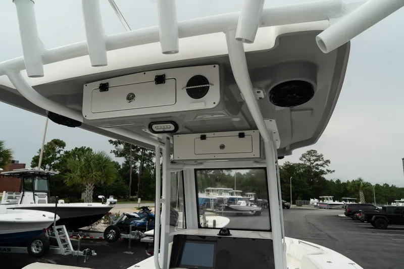 Slide: The Image of 2023 Blue Wave 2600 Makaira boat console with storage and speakers. - 23