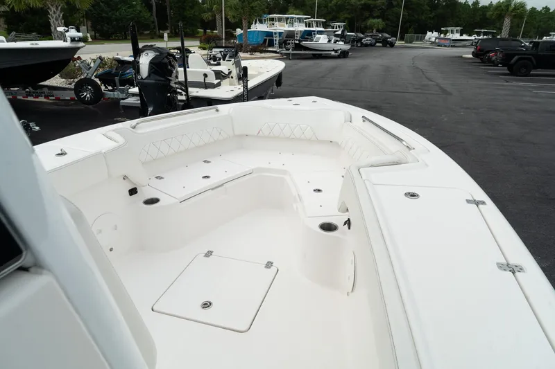 Slide: The Image of 2023 Blue Wave 2600 Makaira boat interior with spacious seating and storage compartments. - 24