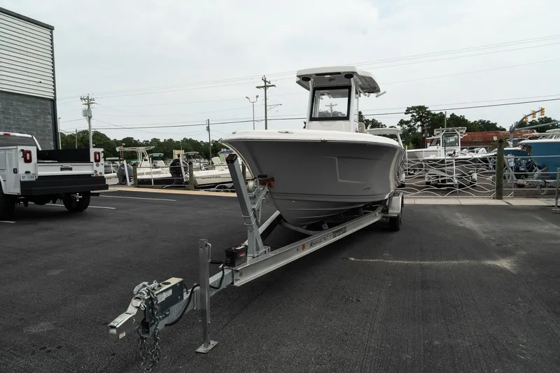 Slide: The Image of 2023 Blue Wave 2600 Makaira boat on trailer in parking lot. - 3