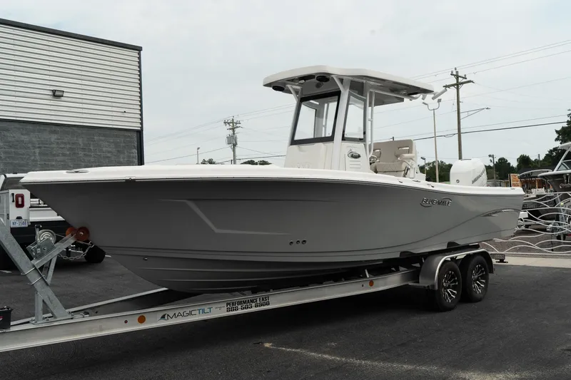Slide: The Image of 2023 Blue Wave 2600 Makaira boat on trailer, parked outdoors. - 4