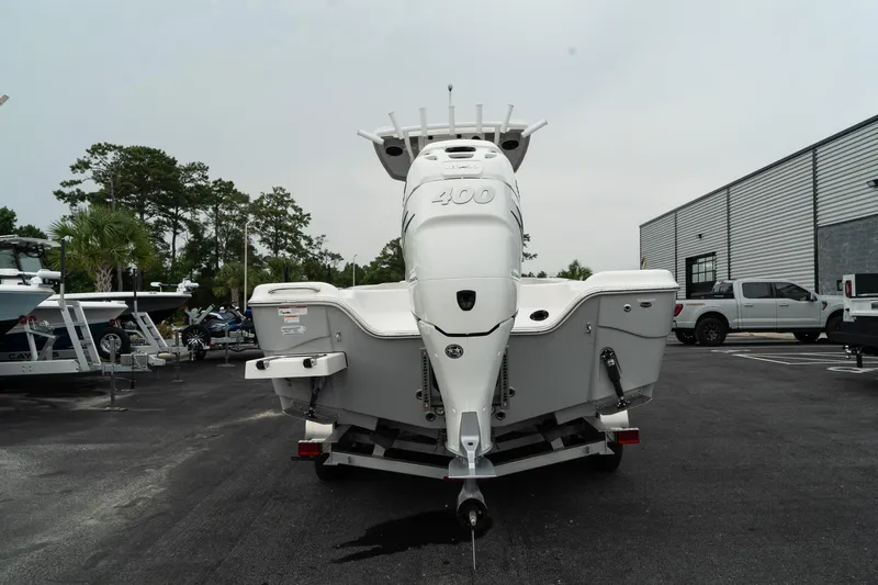 Slide: The Image of 2023 Blue Wave 2600 Makaira boat, rear view, parked on trailer in a lot. - 7