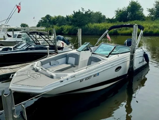 The Image of 2022 NauticStar 243 DC boat docked in a marina, featuring sleek design and comfortable seating. - 0