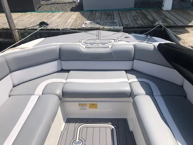 Slide: The Image of 2022 NauticStar 243 DC boat interior with gray and white seating. - 10