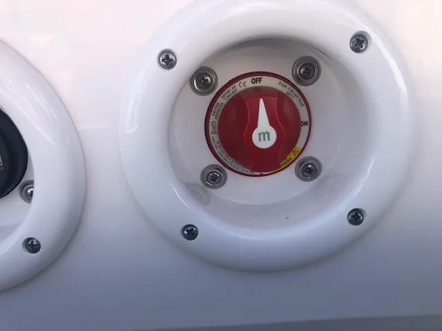Slide: The Image of Close-up of a 2022 NauticStar 243 DC boat control switch. - 14
