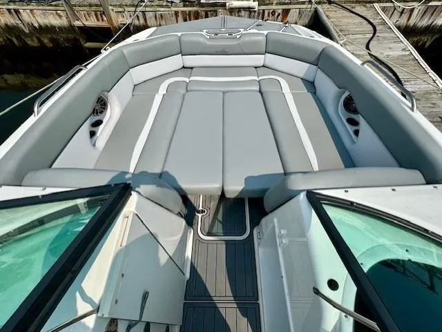 Slide: The Image of 2022 NauticStar 243 DC boat with spacious gray seating and sleek design. - 3