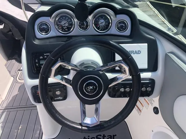 Slide: The Image of 2022 NauticStar 243 DC dashboard with steering wheel and instrument panel. - 4