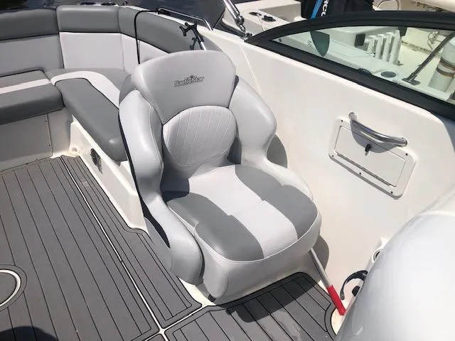 Slide: The Image of 2022 NauticStar 243 DC boat interior with gray seating and sleek design. - 8
