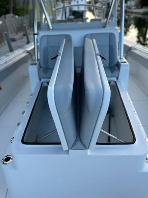 Slide: The Image of 2021 SeaHunter 41 CTS boat with open storage compartments and cushioned seating. - 10