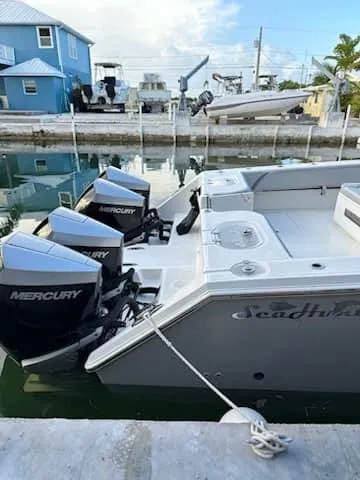 Slide: The Image of 2021 SeaHunter 41 CTS boat docked with triple Mercury engines. - 11