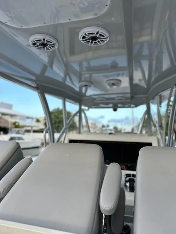Slide: The Image of 2021 SeaHunter 41 CTS boat interior with modern seating and overhead speakers. - 13