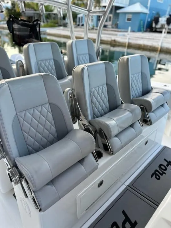 Slide: The Image of Luxurious seating on 2021 SeaHunter 41 CTS boat, featuring elegant gray upholstery. - 14