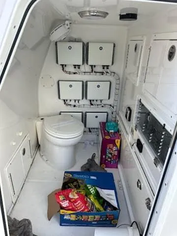 Slide: The Image of 2021 SeaHunter 41 CTS interior with toilet, storage, and snacks. - 15