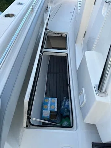 Slide: The Image of 2021 SeaHunter 41 CTS boat storage compartment with beverages. - 17