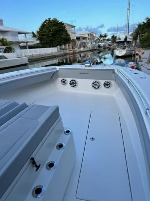 Slide: The Image of 2021 SeaHunter 41 CTS boat docked in a serene marina setting. - 18