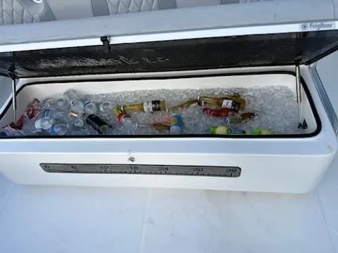 Slide: The Image of Cooler with drinks and ice on a 2021 SeaHunter 41 CTS boat. - 19