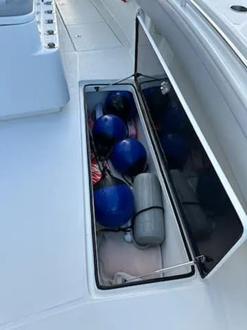 Slide: The Image of Storage compartment on 2021 SeaHunter 41 CTS boat with blue fenders and equipment. - 2