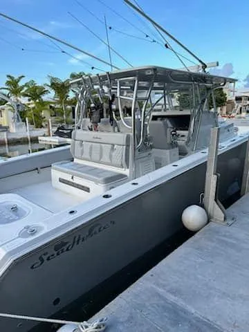 Slide: The Image of 2021 SeaHunter 41 CTS boat docked, featuring sleek design and spacious deck. - 7