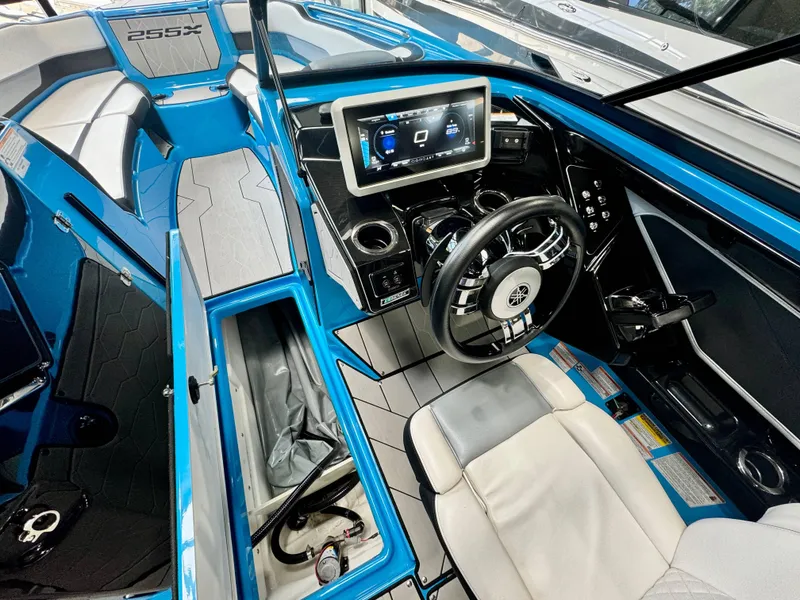 Slide: The Image of Interior of 2022 Yamaha Boats 255XD, featuring sleek dashboard and modern controls. - 10