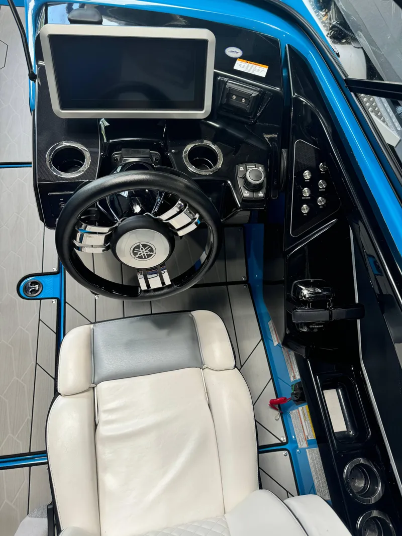Slide: The Image of 2022 Yamaha Boats 255XD cockpit with steering wheel and control panel. - 11