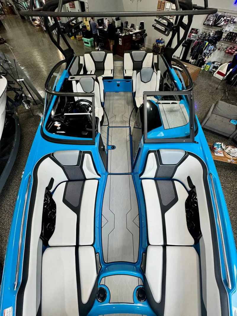 Slide: The Image of 2022 Yamaha Boats 255XD interior, featuring sleek blue and white seating design. - 13