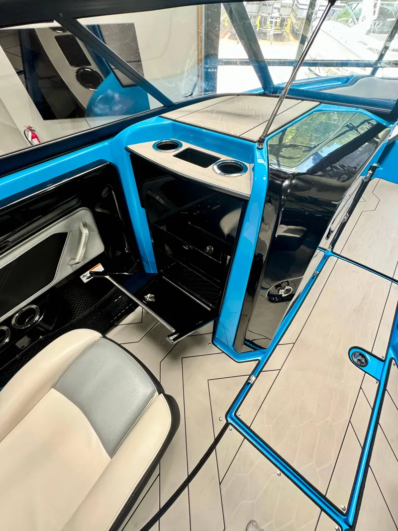 Slide: The Image of 2022 Yamaha Boats 255XD interior with blue accents and modern seating. - 14