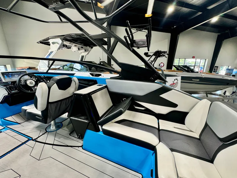 Slide: The Image of Interior of 2022 Yamaha Boats 255XD, featuring sleek seating and modern dashboard in showroom. - 15