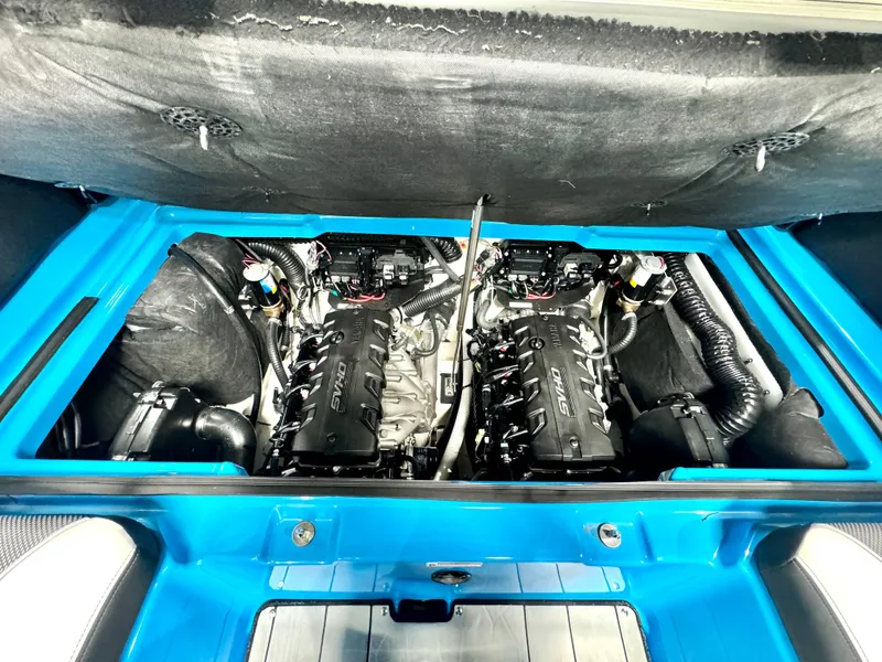 Slide: The Image of 2022 Yamaha Boats 255XD engine compartment with dual engines and blue interior. - 21